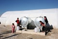 Shariya IDP camp. Water tank with children.